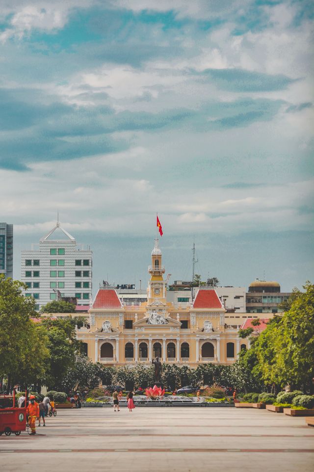 The Architectural Engine: How Artificial Intelligence is defining Human Potential A vibrant cityscape featuring the iconic People's Committee Building in Ho Chi Minh City, Vietnam.