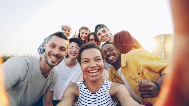 Mobile Responsiveness: The Definitive Guide to Building for a Mobile-First World A diverse group of friends taking a joyful selfie outdoors during sunset.